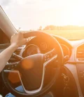 A woman driving a car, focused on the road ahead.