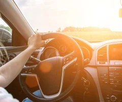 A woman driving a car, focused on the road ahead.