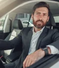 A woman driving a car, focused on the road ahead.