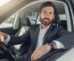 A woman driving a car, focused on the road ahead.