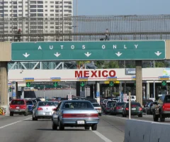 Cars waiting to cross the border, lined up at a border crossing checkpoint