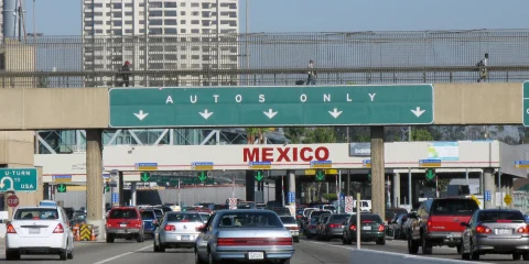 Cars waiting to cross the border, lined up at a border crossing checkpoint