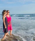 Two women gazing at the sea, enjoying the view together.