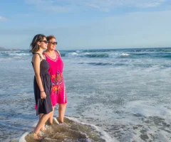 Two women gazing at the sea, enjoying the view together.