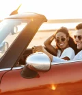 A couple enjoying a scenic drive in a convertible car