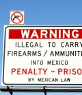 A warning sign displaying the message that it is illegal to cross arms into Mexico.