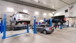 A car in a repair shop, getting ready to be fixed after a breakdown or damage