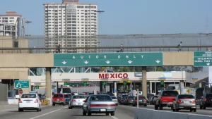 vehicles waiting to obtain the temporary vehicle importation permit at a Mexican border crossing.