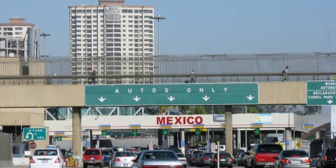 vehicles waiting to obtain the temporary vehicle importation permit at a Mexican border crossing.