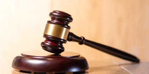 Close-up of a judge's gavel on the bench in a courtroom