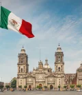 A panoramic view of El Zócalo in Mexico City with the Mexican flag