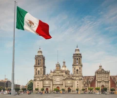 A panoramic view of El Zócalo in Mexico City with the Mexican flag