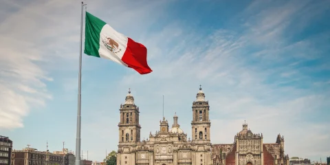 A panoramic view of El Zócalo in Mexico City with the Mexican flag