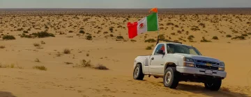 Car driving with a Mexican flag waving from the co-pilot window